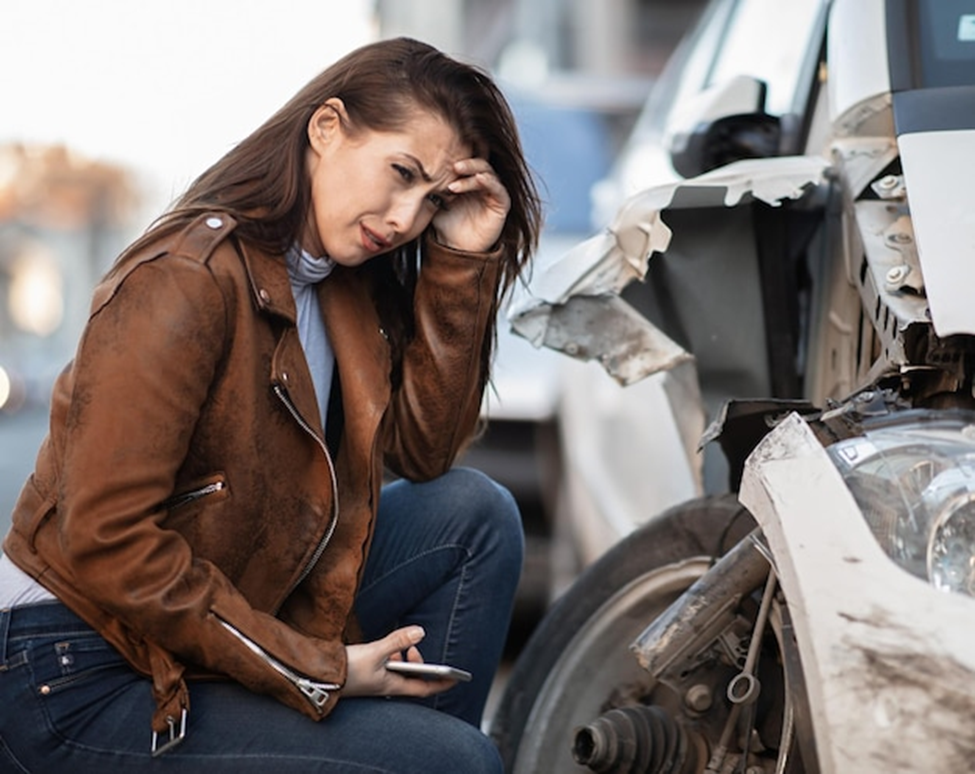 girl at car accident site
