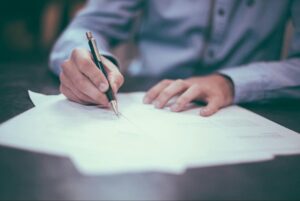 Man with Copybook an Pen - Estate Plan