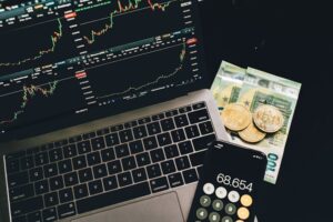Laptop screen depicting stock chart and a calculator