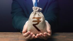 Man holding a bag of rupees with both hand - EMI Financing for Online Shopping