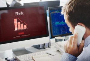 Man on call seeing computer screen business risk graph