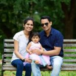 Couple with kid sitting in the Park