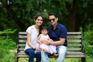 Couple with kid sitting in the Park