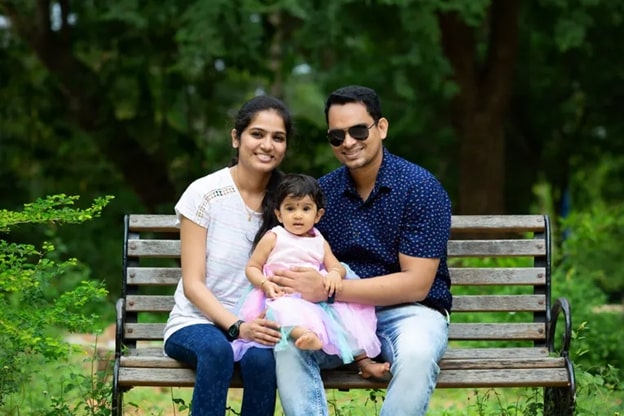 Couple with kid sitting in the Park