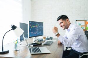 Trader in happy mode with Laptop with tarding graph (1)