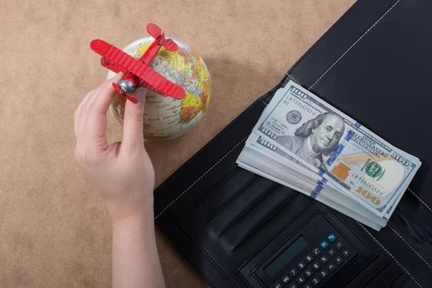 Image demonstrating globe-laptop and currency in dollor