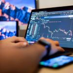 Trader analyzing forex spreads on a laptop